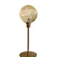 Table lamp with an antique golden streaked globe and a golden foot