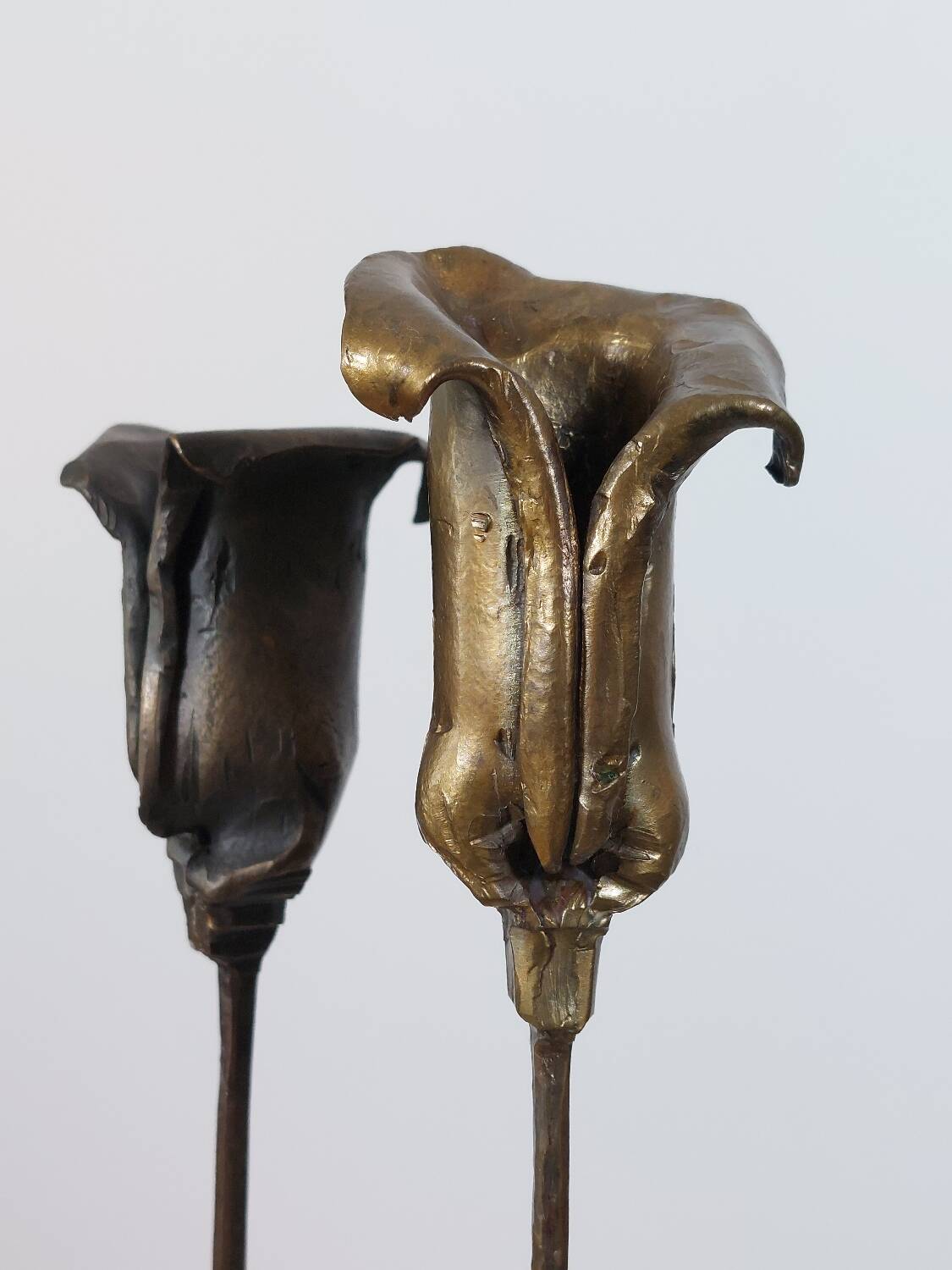 Pair of vintage brass candle holders with tulip decoration.