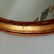 Antique oval mirror in gilded solid wood