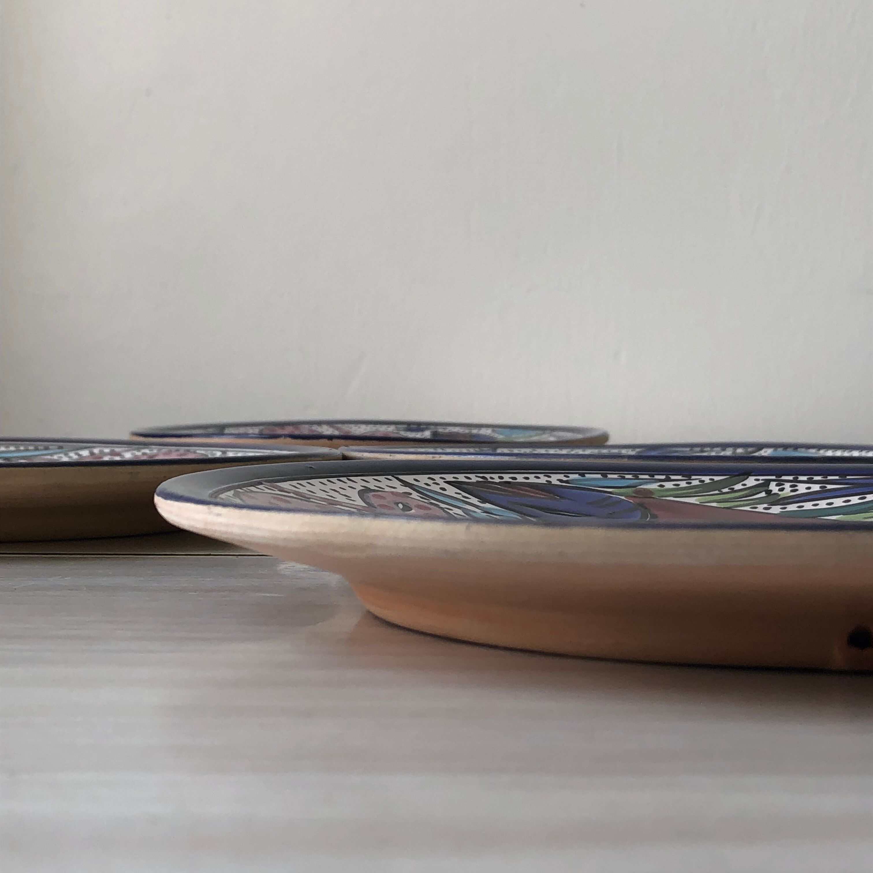 4 colorful flat plates with a fish pattern