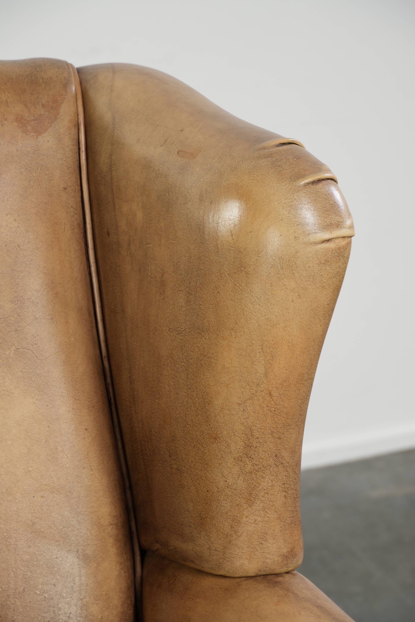 Comfortable cowhide wingback armchair with a timeless English look