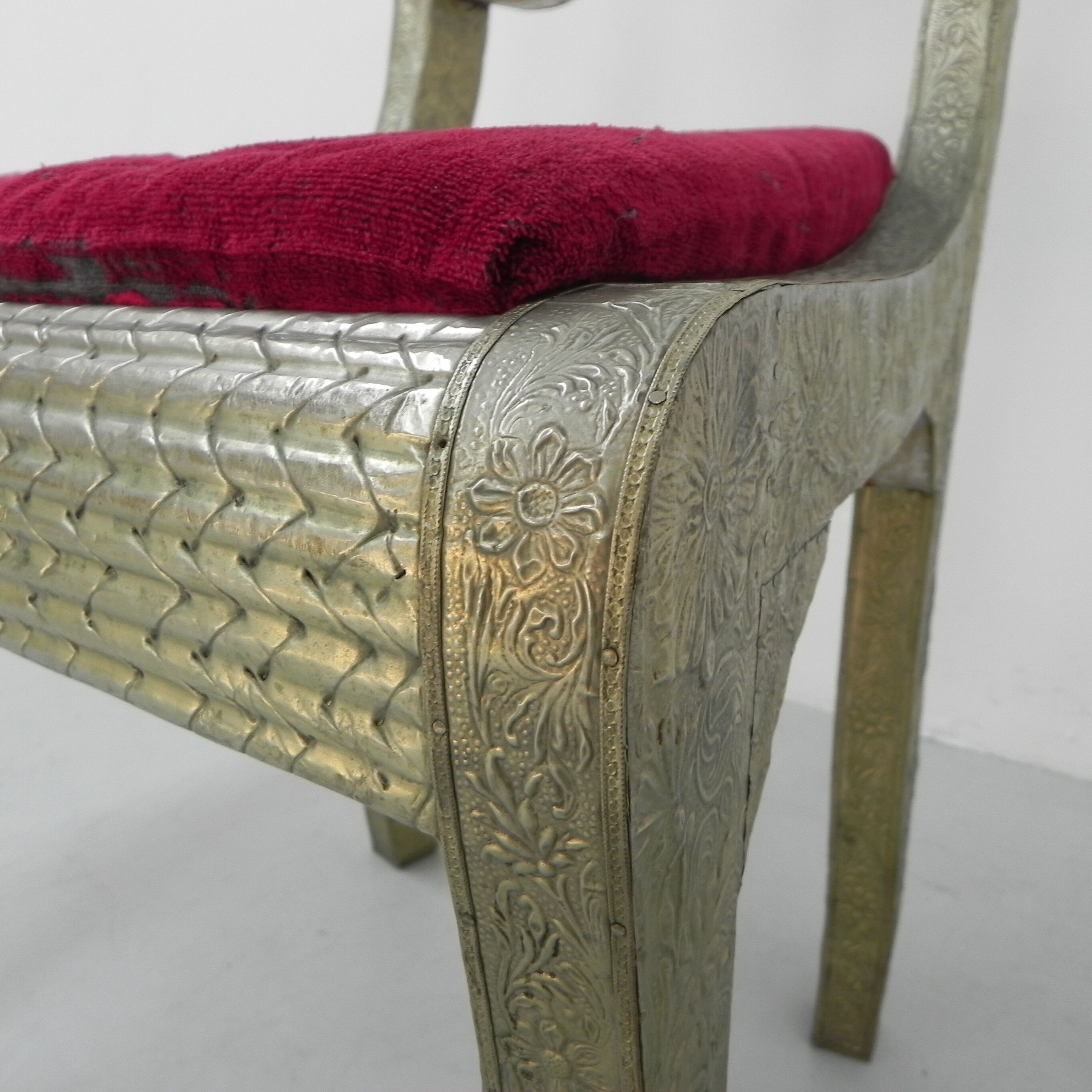 Dining chair upholstered with stamped tin
