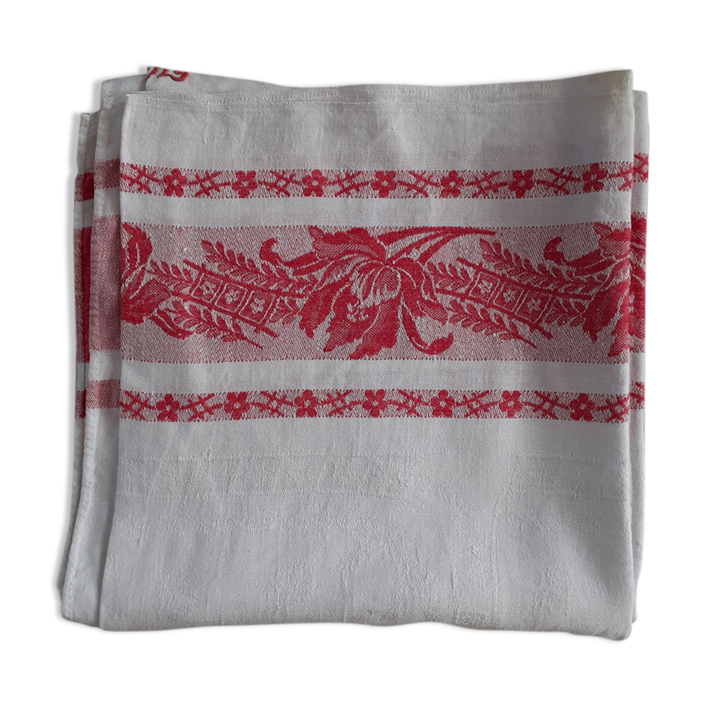 Ancient damask tablecloth. Surroundings borders red. Red central monogram.