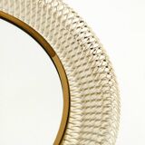 Mid Century Modern round wall mirror with a white expanded metal frame