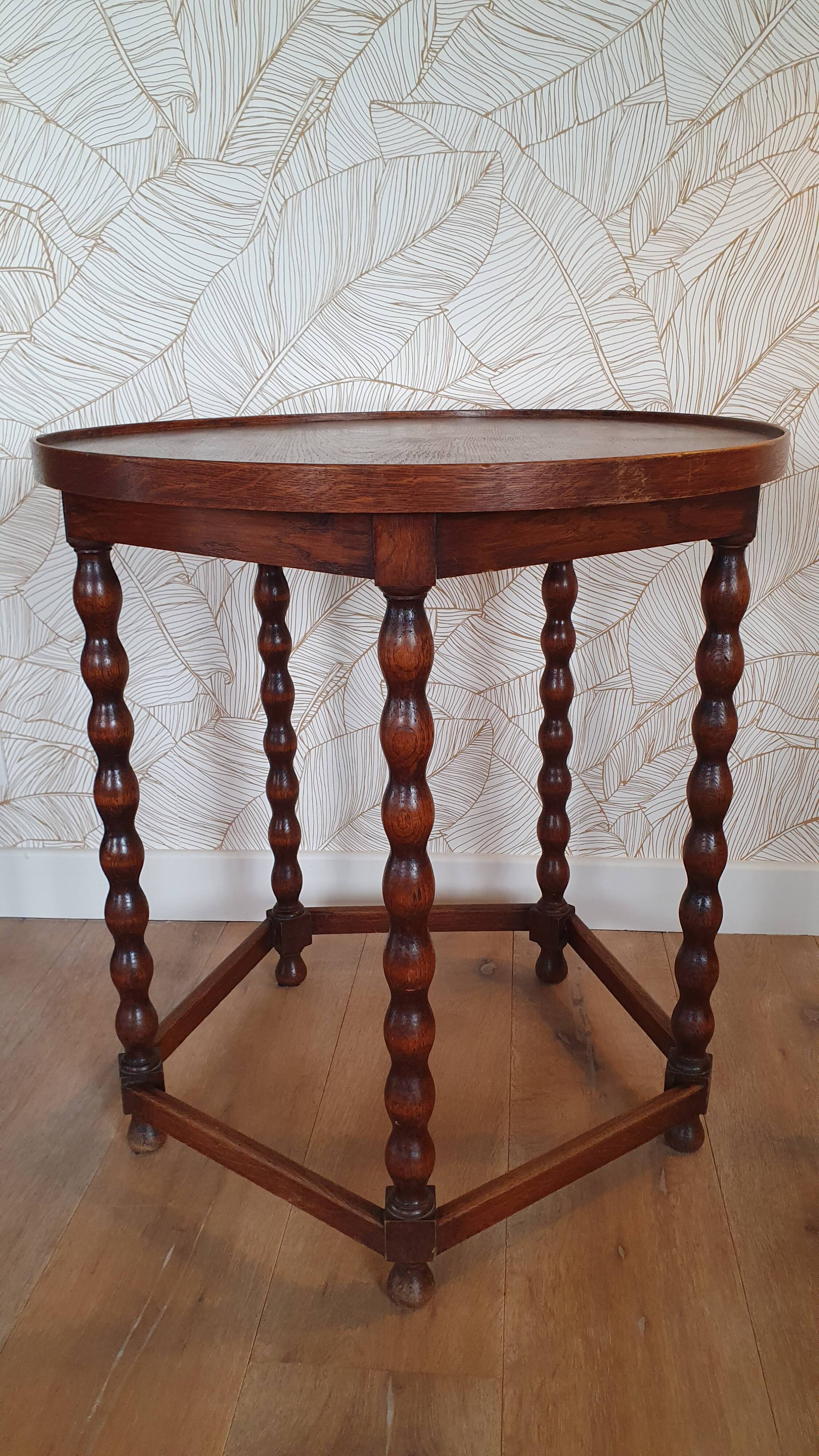 Round wooden table with beaded legs