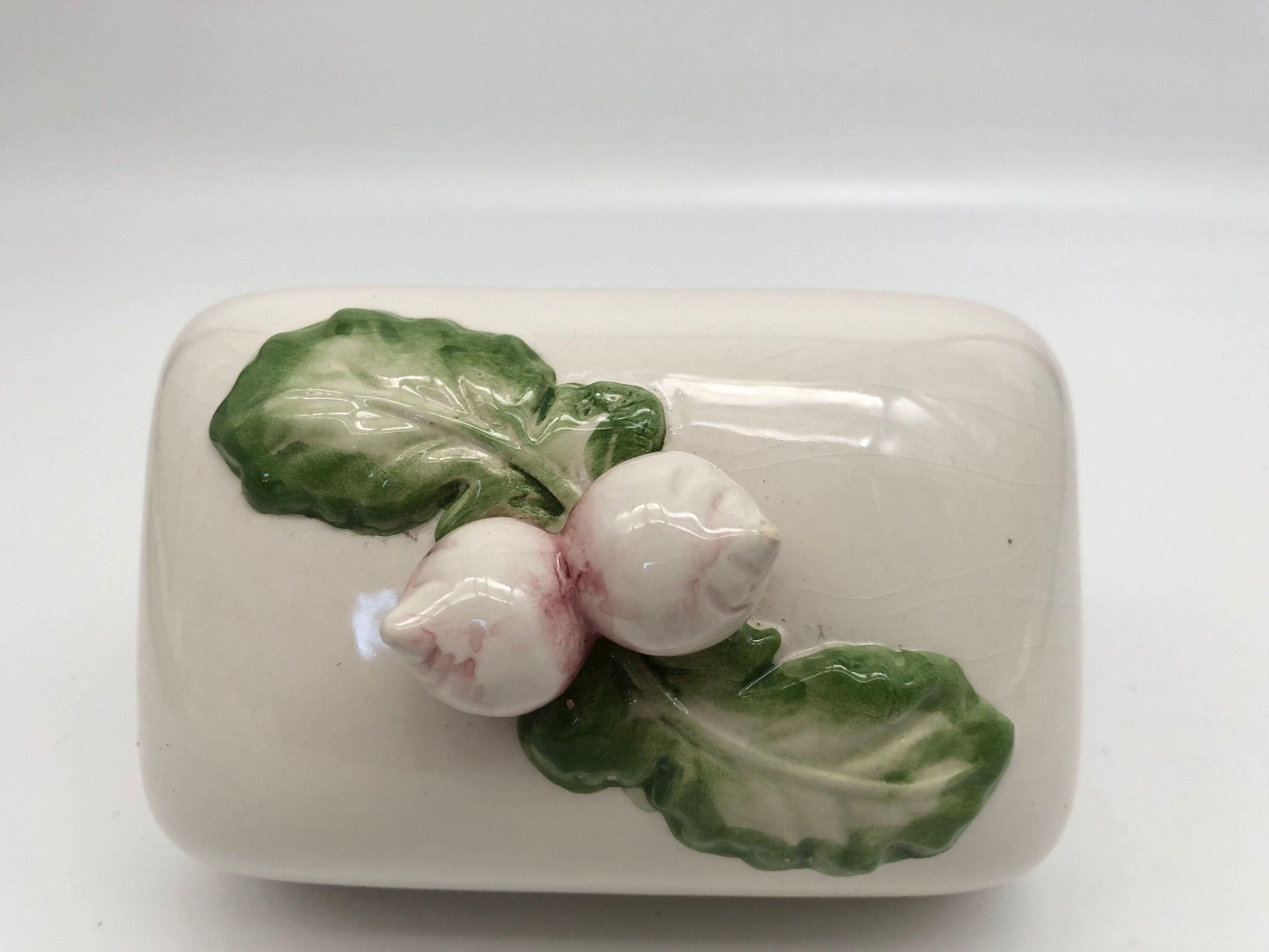 Slurry butter dish, with radish drawings. Signed "FG"