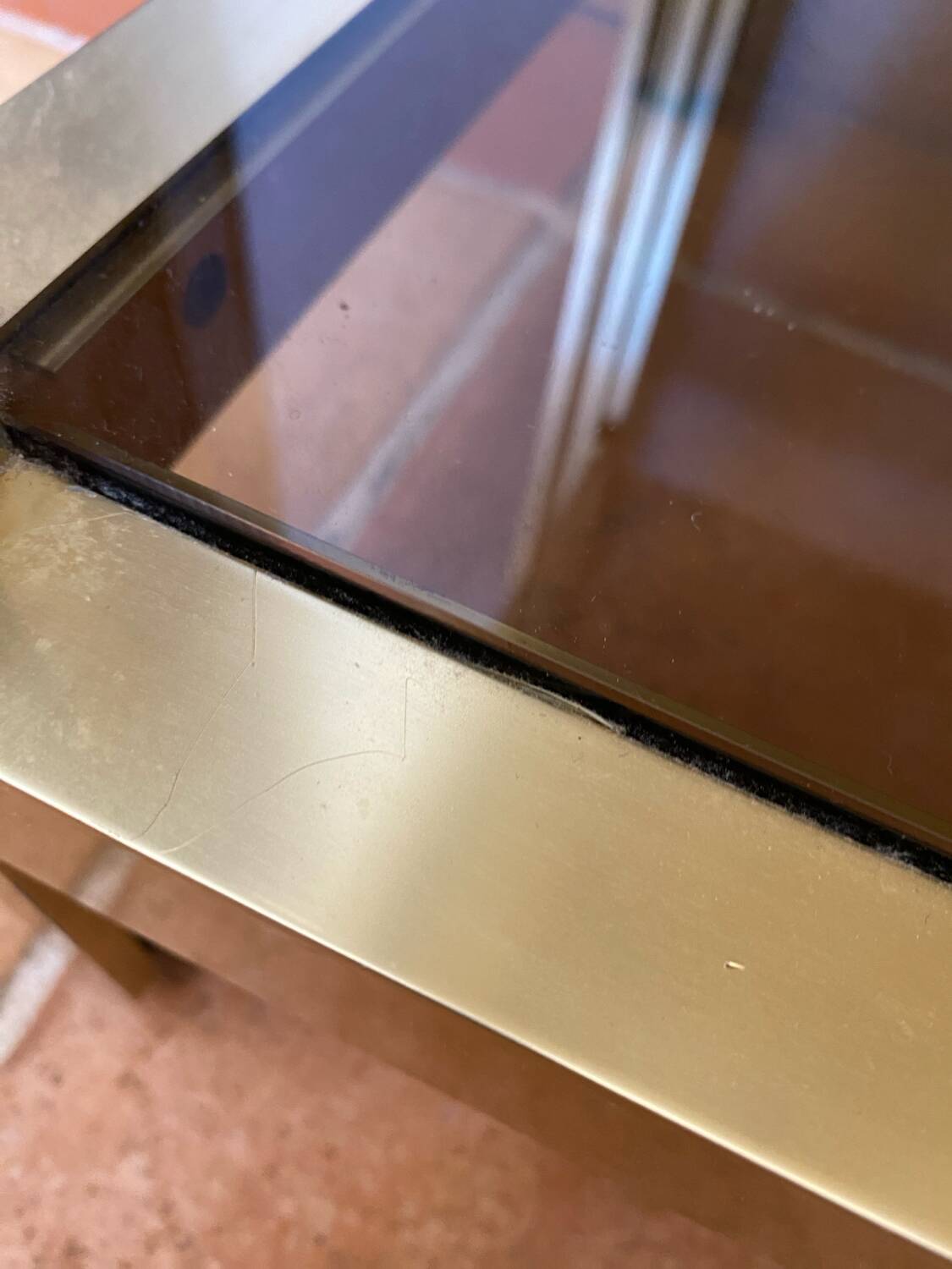 Regency style console table, in gilded metal and smoked glass