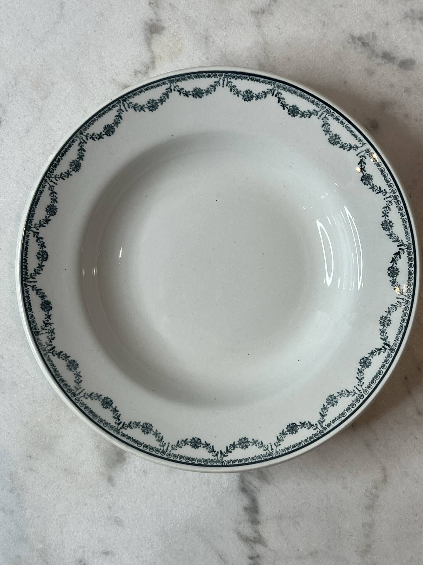 Set of 12 deep plates Saint Amand with floral garland decoration.