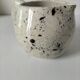Small speckled ceramic jug in a vintage workshop style.