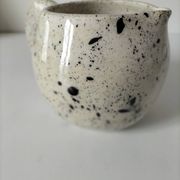 Small speckled ceramic jug in a vintage workshop style.