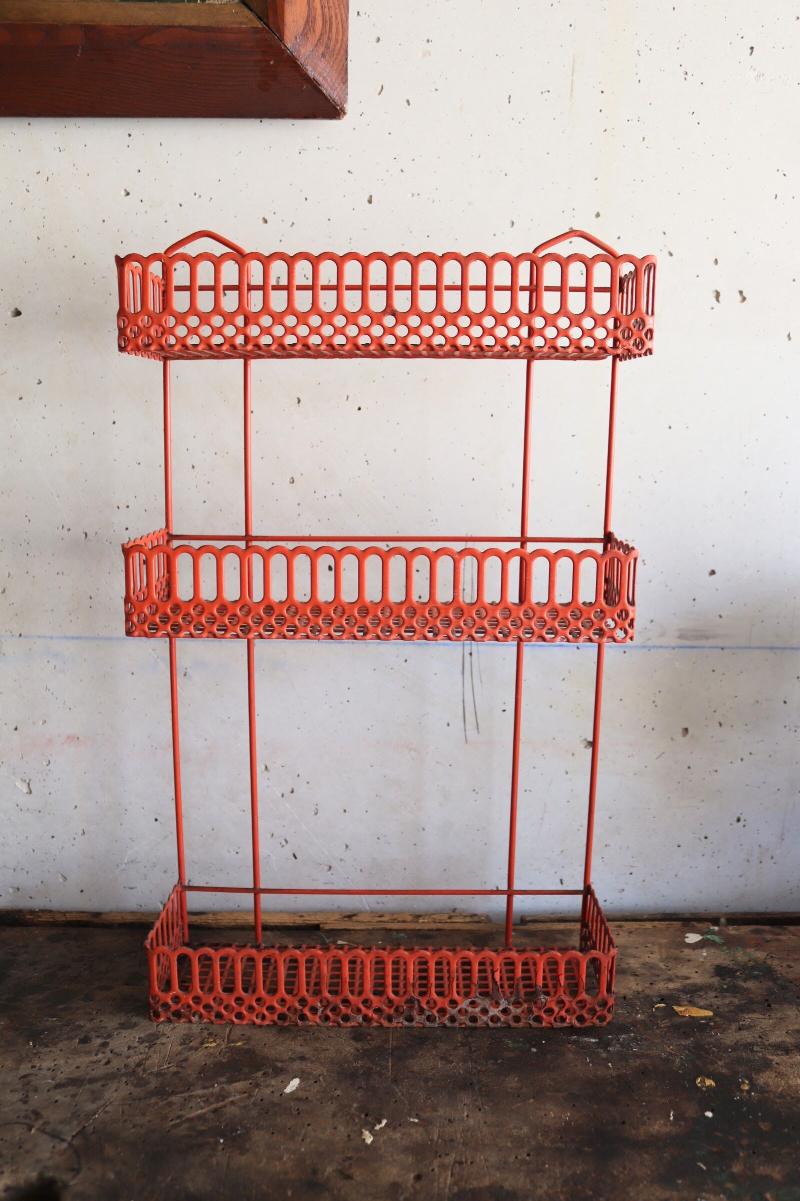 Vintage shelf in red openwork metal