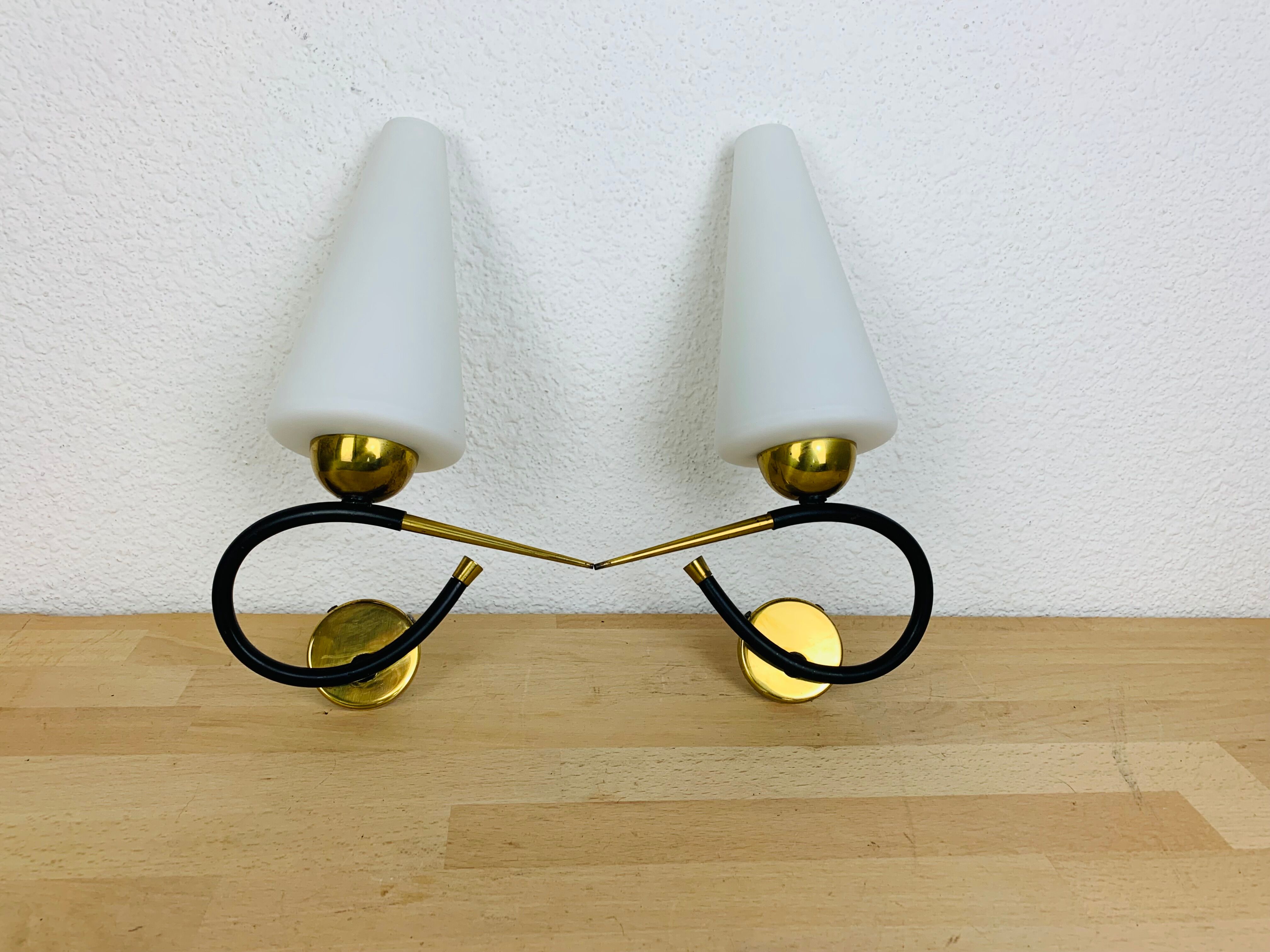 Pair of Arlus 50s opaline black and golden brass wall lamps