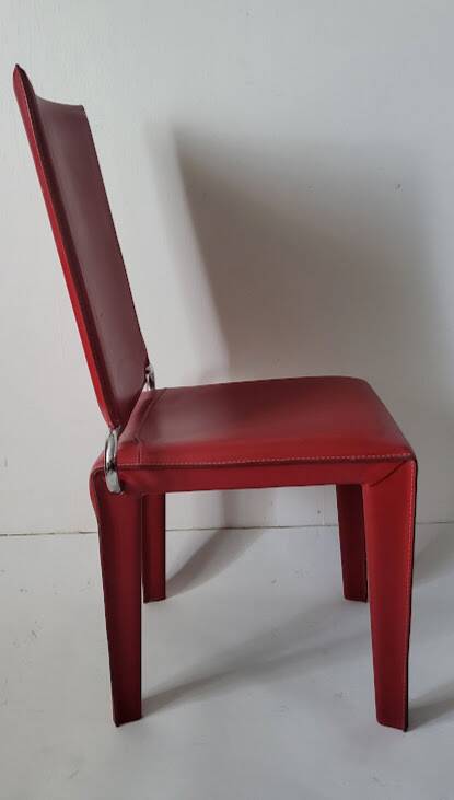 Red leather dining chairs by Arper