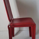 Red leather dining chairs by Arper