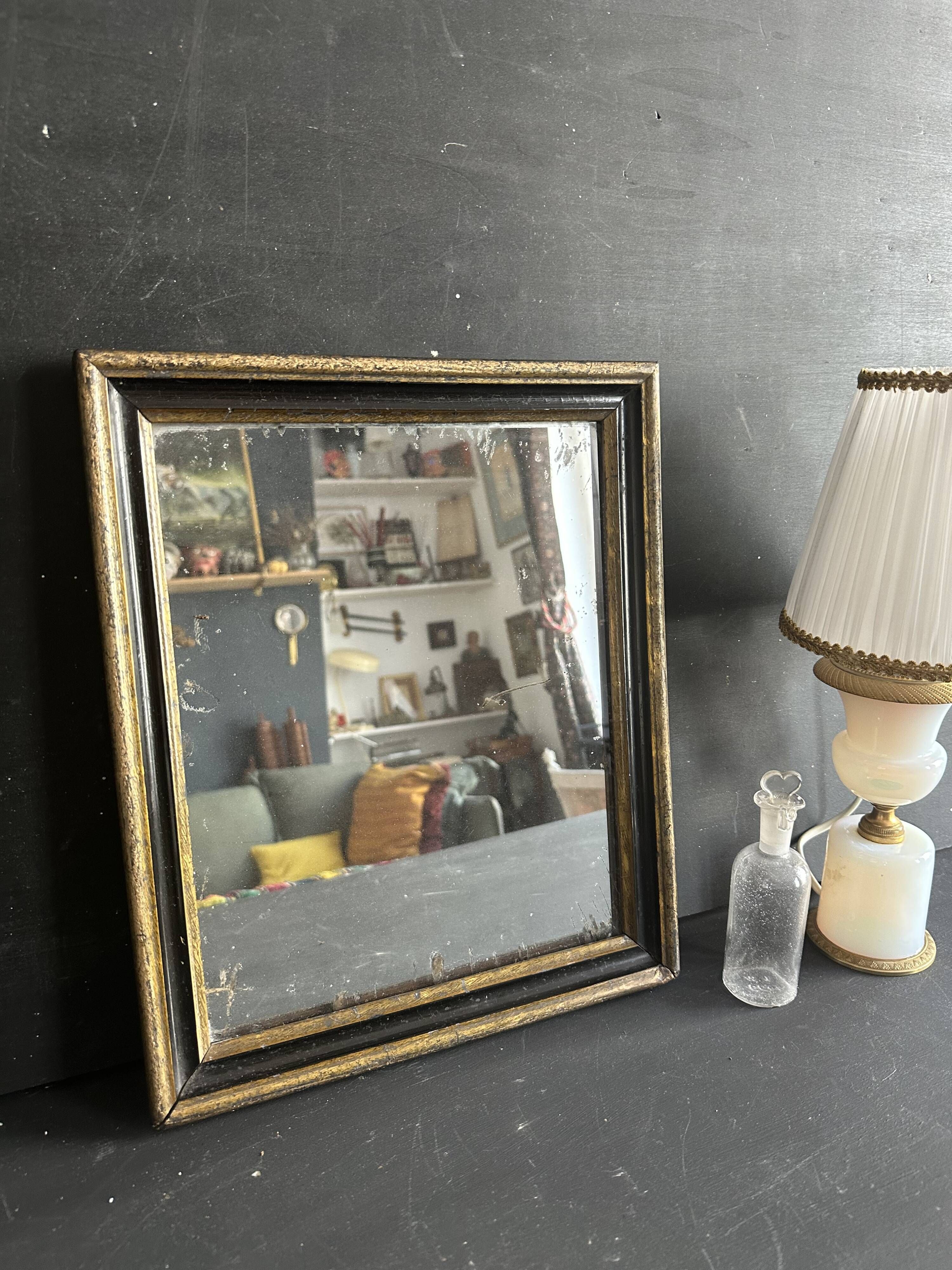Miroir Napoléon III en bois noir et doré, XIXe siècle