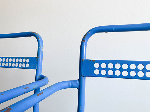 Pair of perforated metal garden chairs