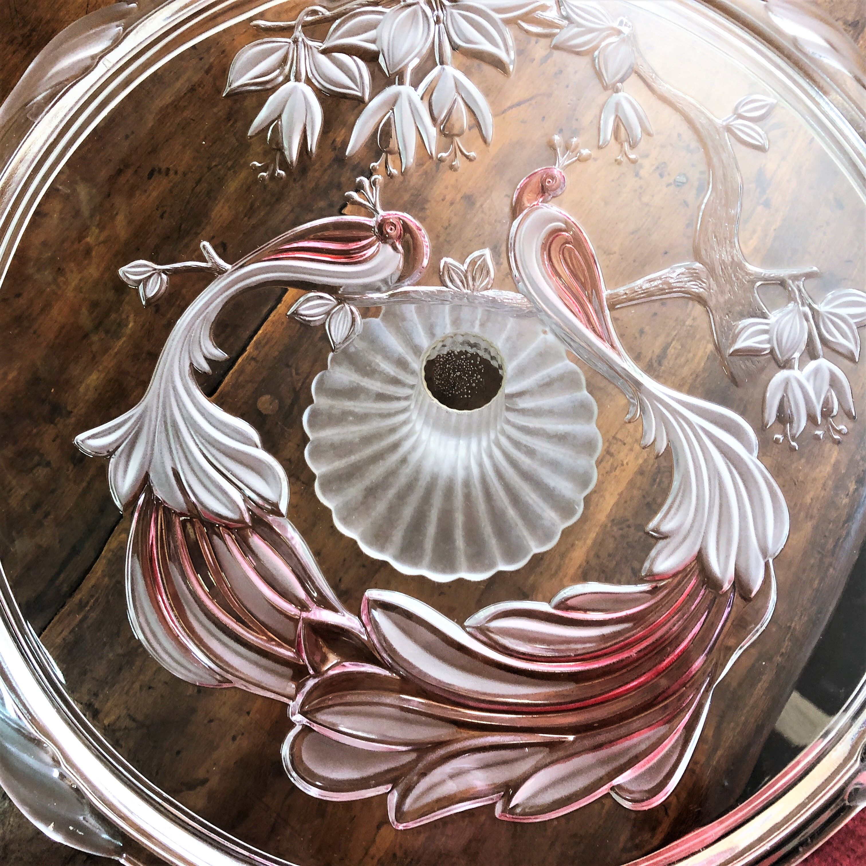 Large pie dish cakes on pedestal decorated with peacocks