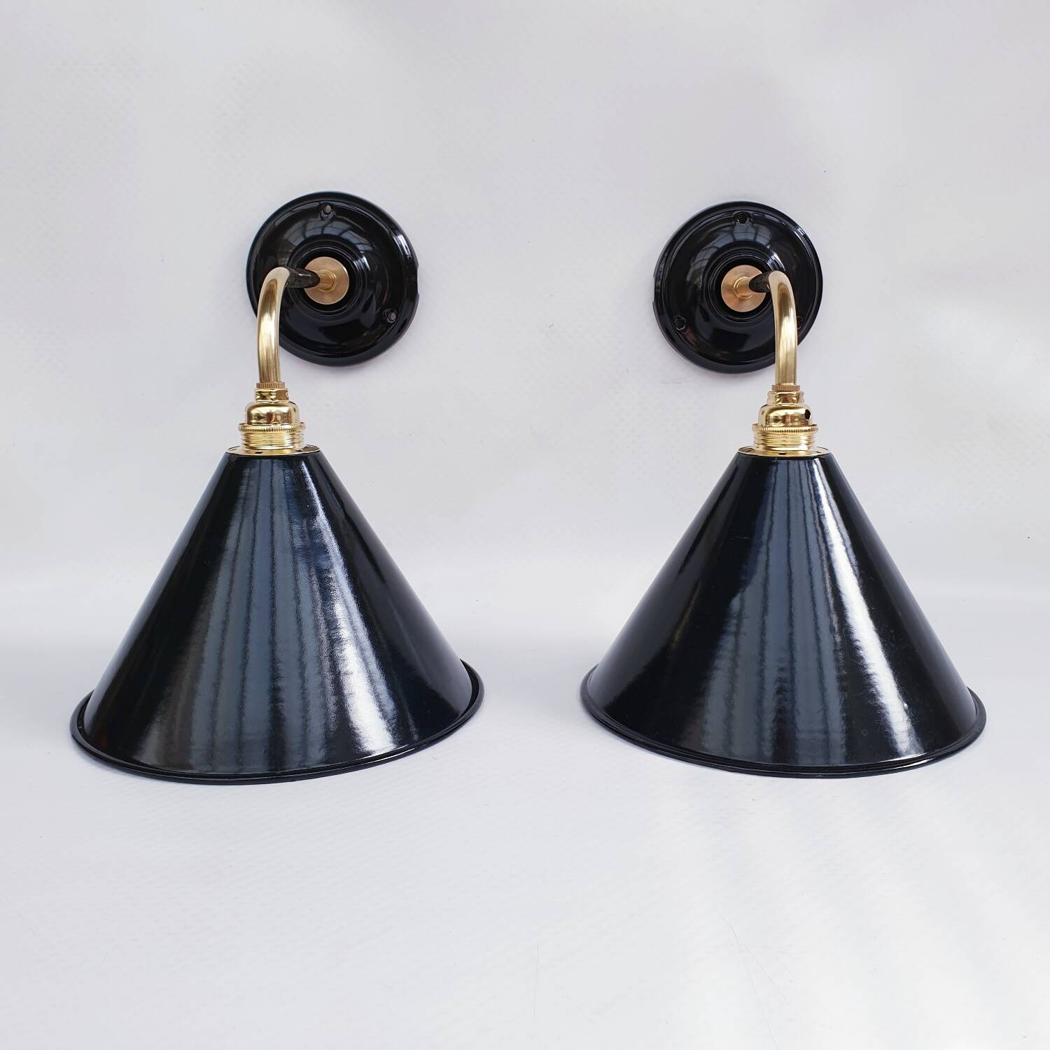 Pair of antique black enamelled sheet metal wall lights