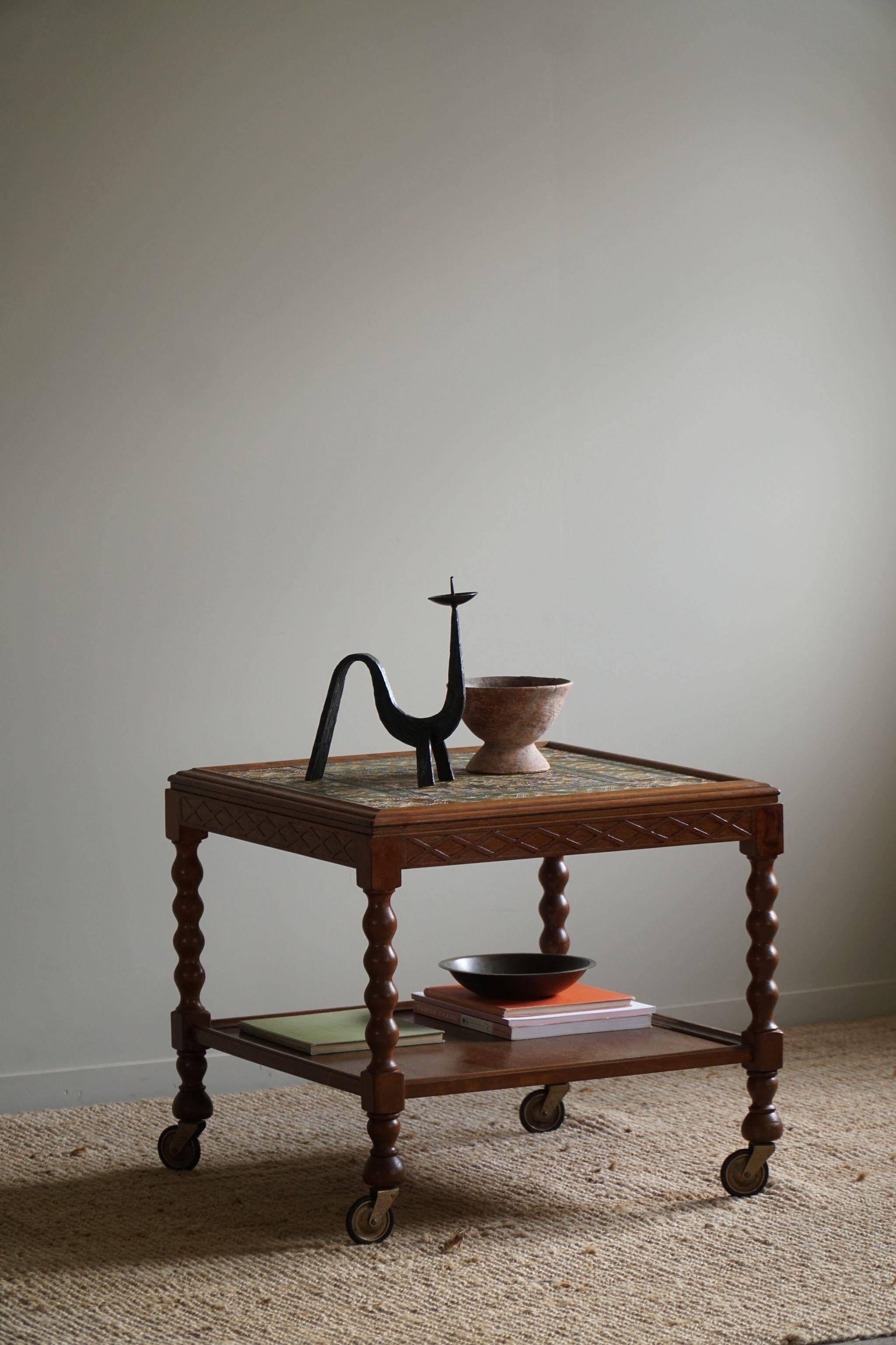 Modern Danish service table with turned spool legs and coloured tiles, 1950s.