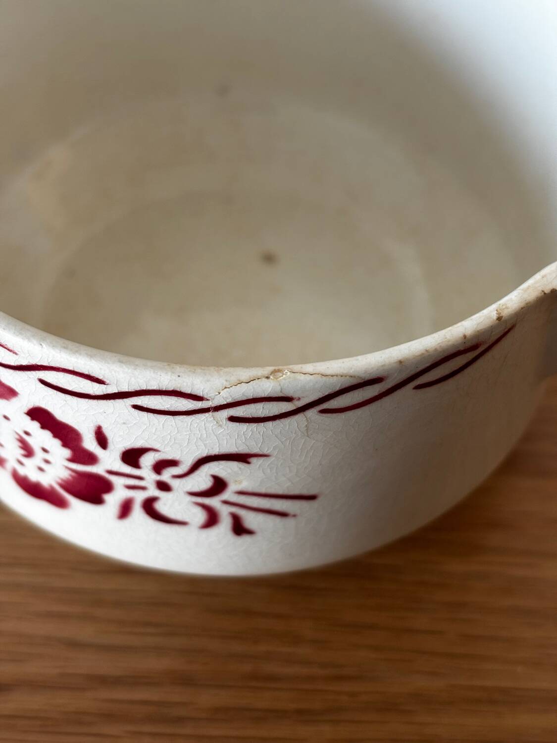 Vintage old sauceboat with pink flowers in St Amand