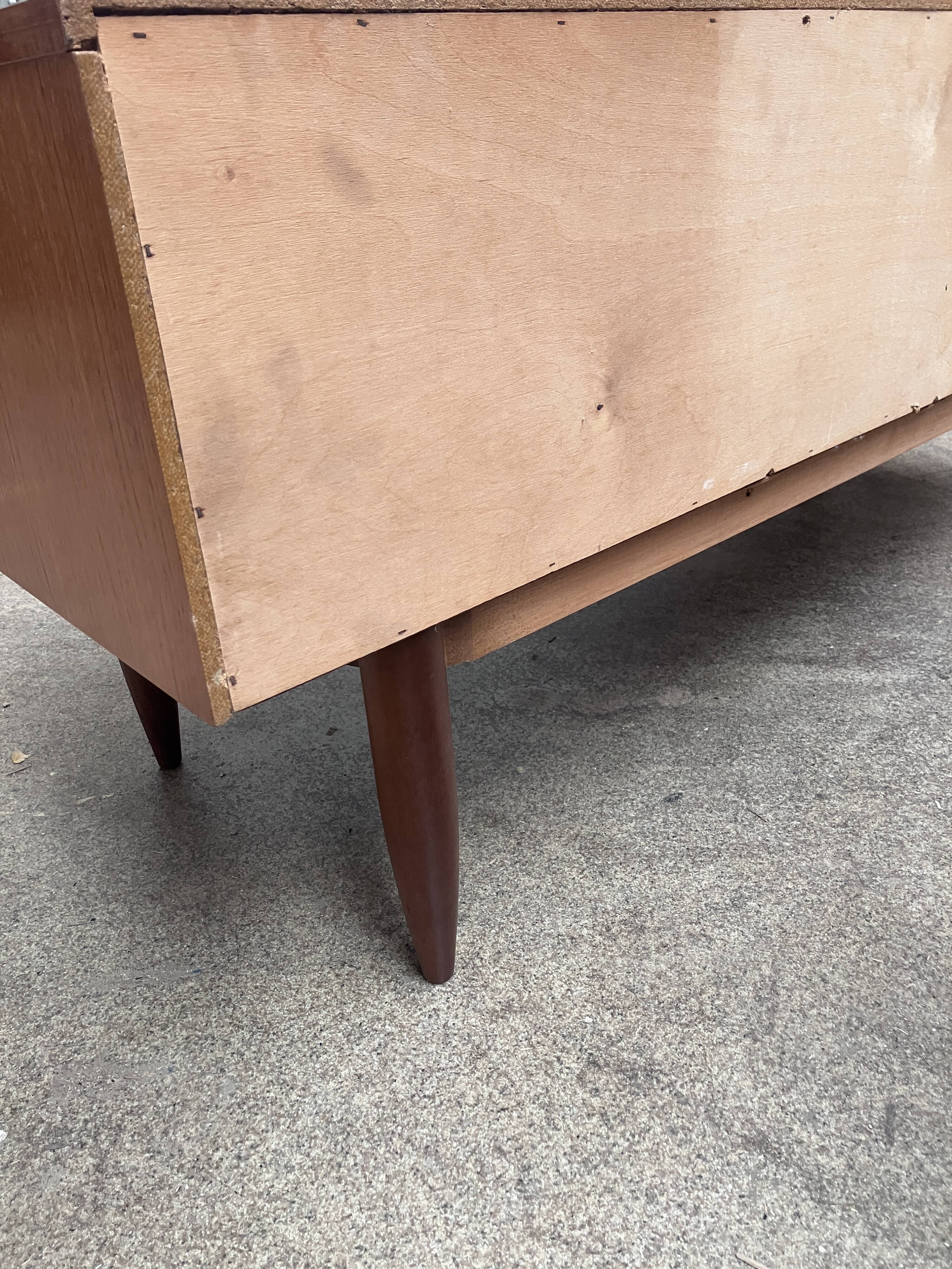 Teak sideboard with flap, 2 drawers and conical legs.