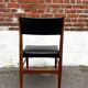 Set of 2 vintage Scandinavian chairs in wood and black faux leather.