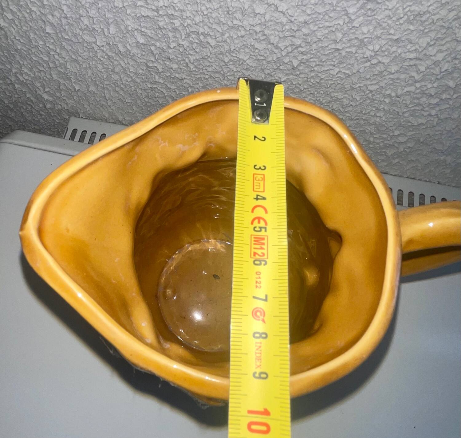 Antique pitcher with flower decoration