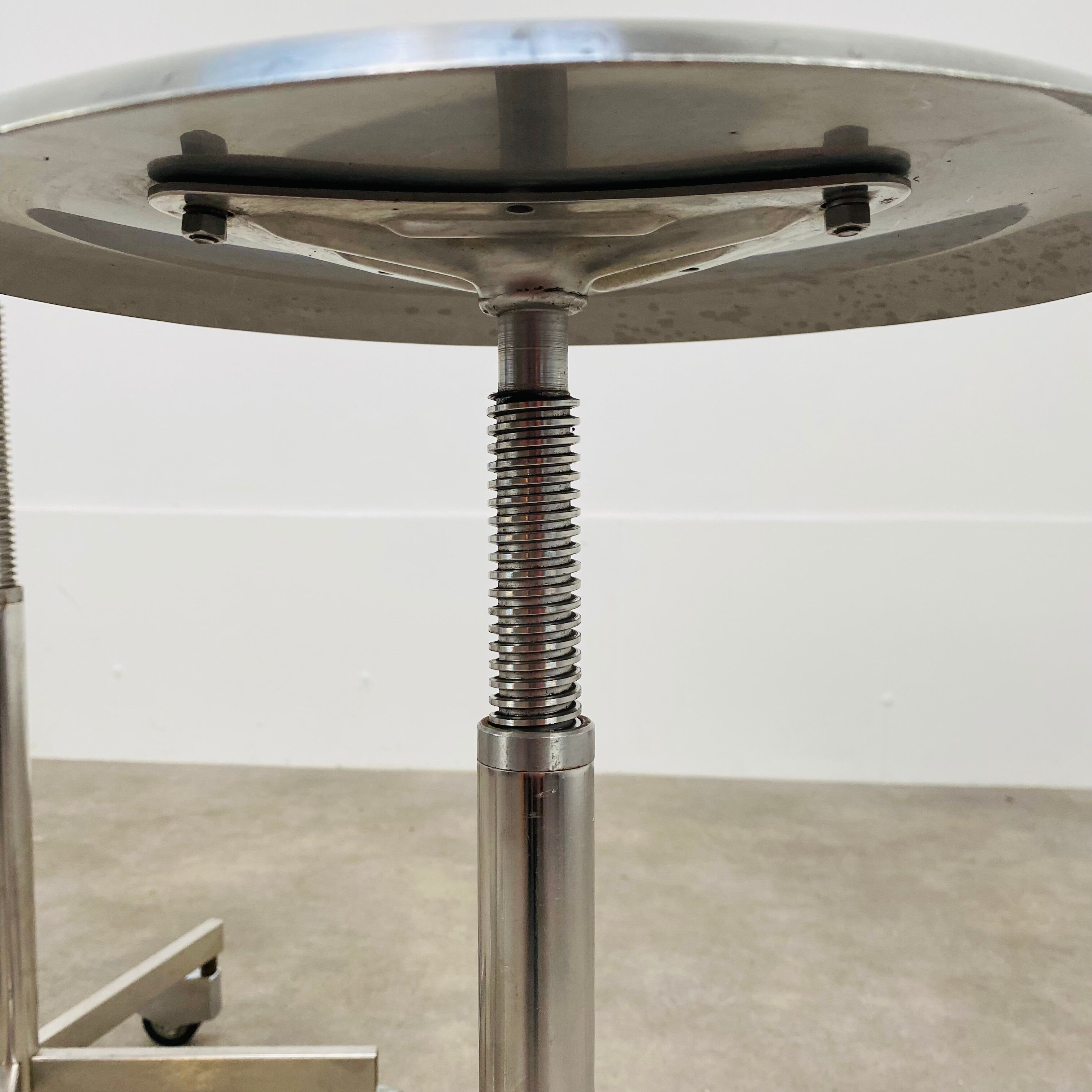 3 adjustable industrial stools with aluminum wheels