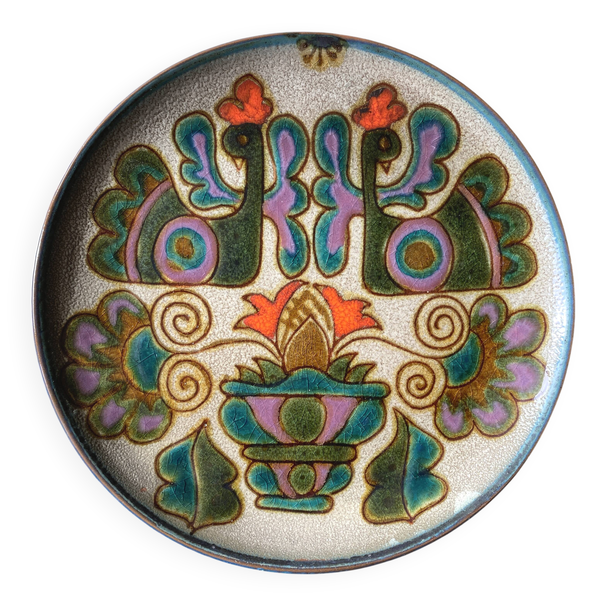 Vintage ceramic plate with peacock bird decoration.