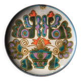 Vintage ceramic plate with peacock bird decoration.