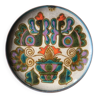 Vintage ceramic plate with peacock bird decoration.