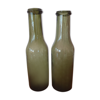 Pair of green bottles made of bubbled blown glass