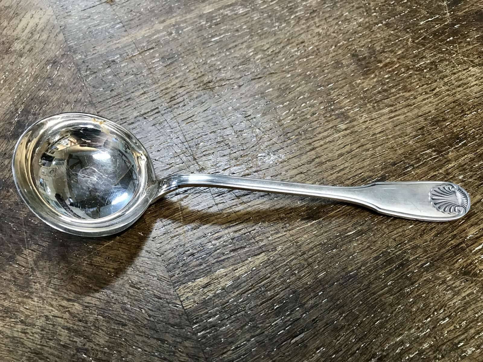 Small silver metal ladle from the Christofle brand, shell model