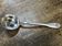 Small silver metal ladle from the Christofle brand, shell model