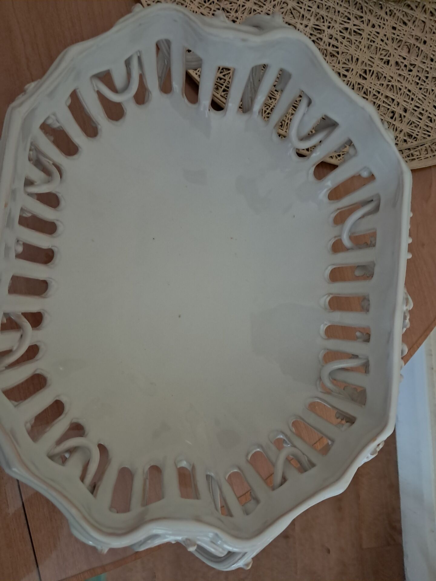 Malicorne fruit bowl in white pierced faience with monogram TE.