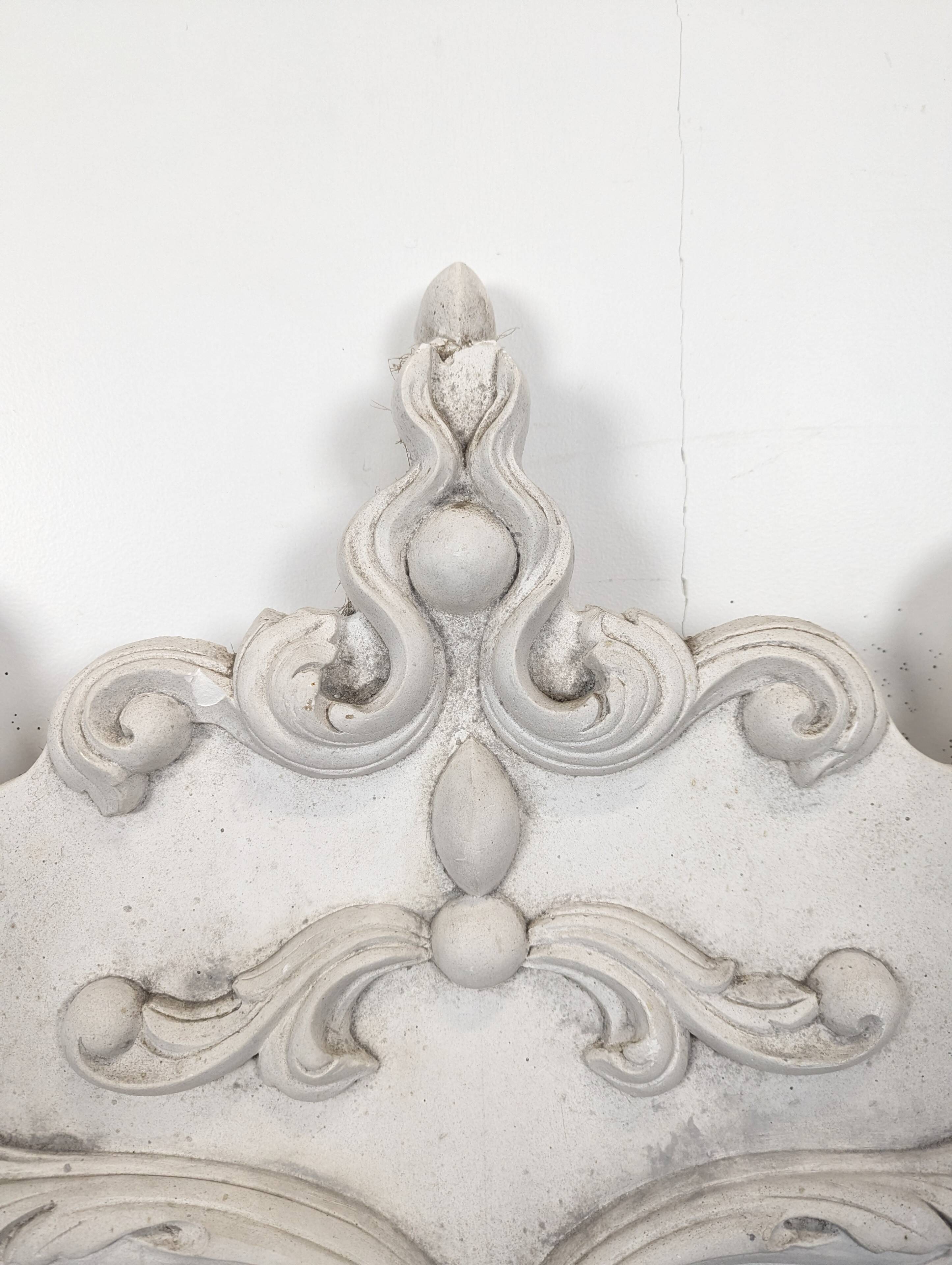 Large rococo fronton in stucco and carved wood, patinated white with an oculus.