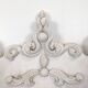 Large rococo fronton in stucco and carved wood, patinated white with an oculus.