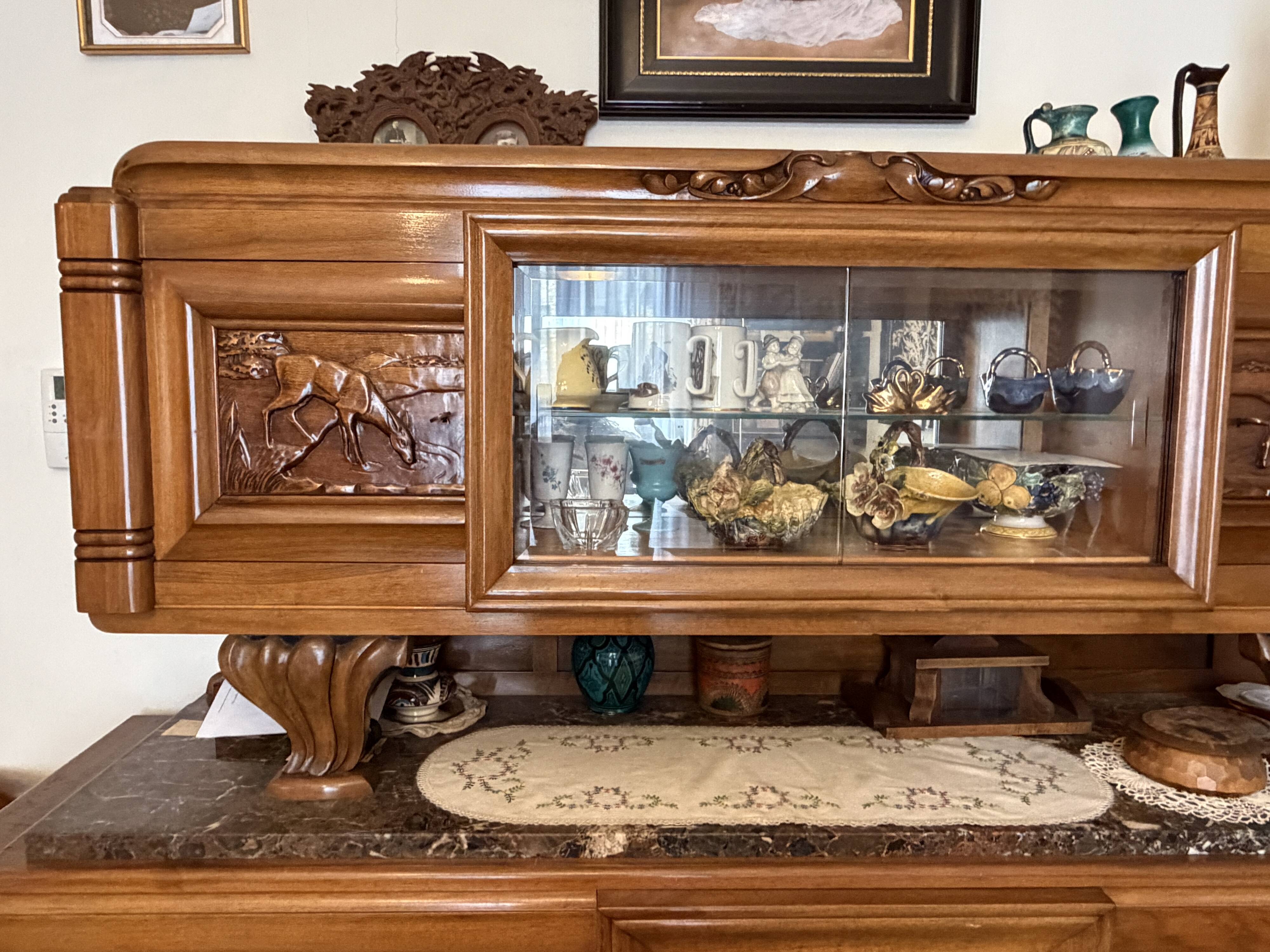 Solid wood sideboard with marble top and carved panels.