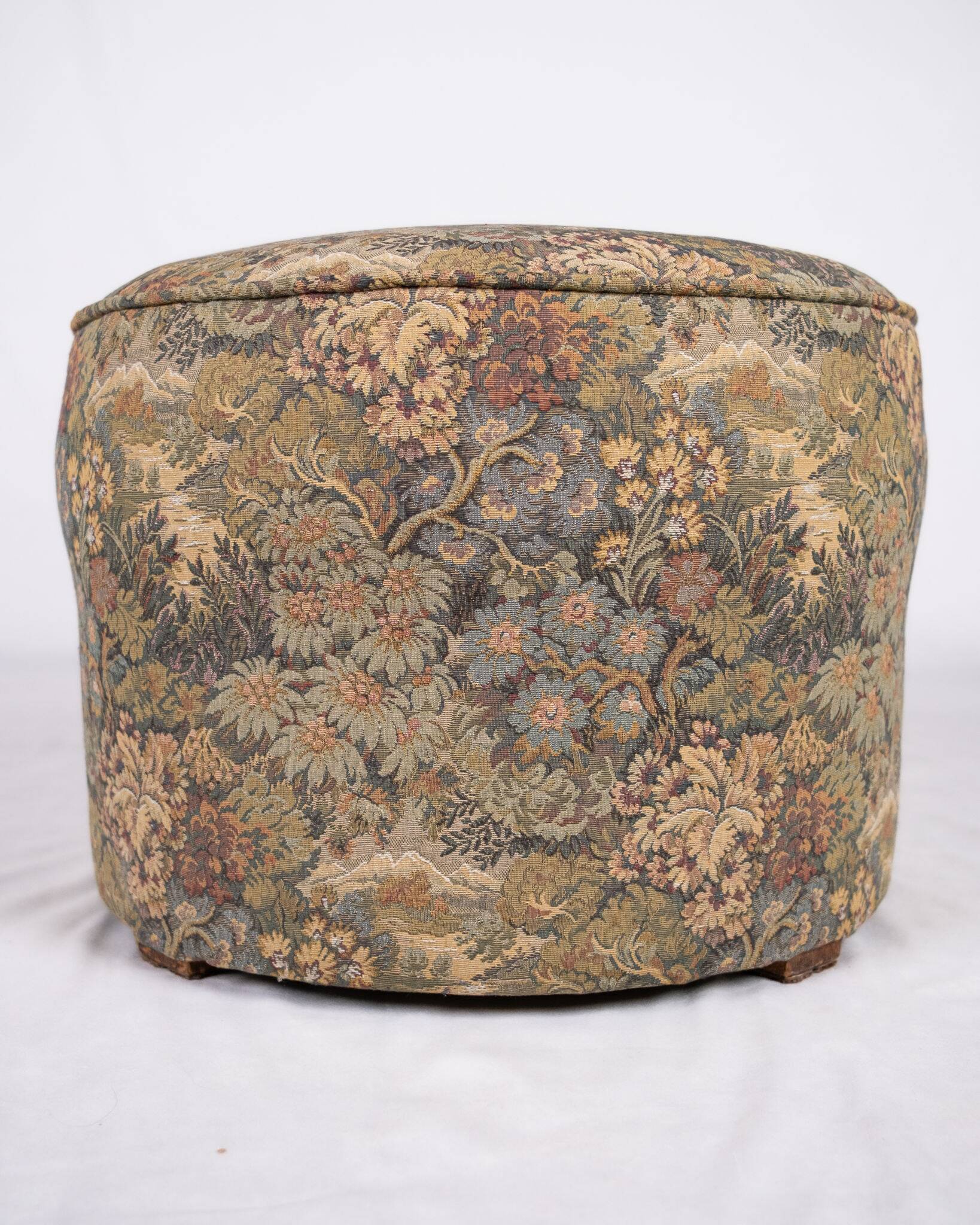 Upholstered pouf in verdure tapestry style, France, late 19th century.