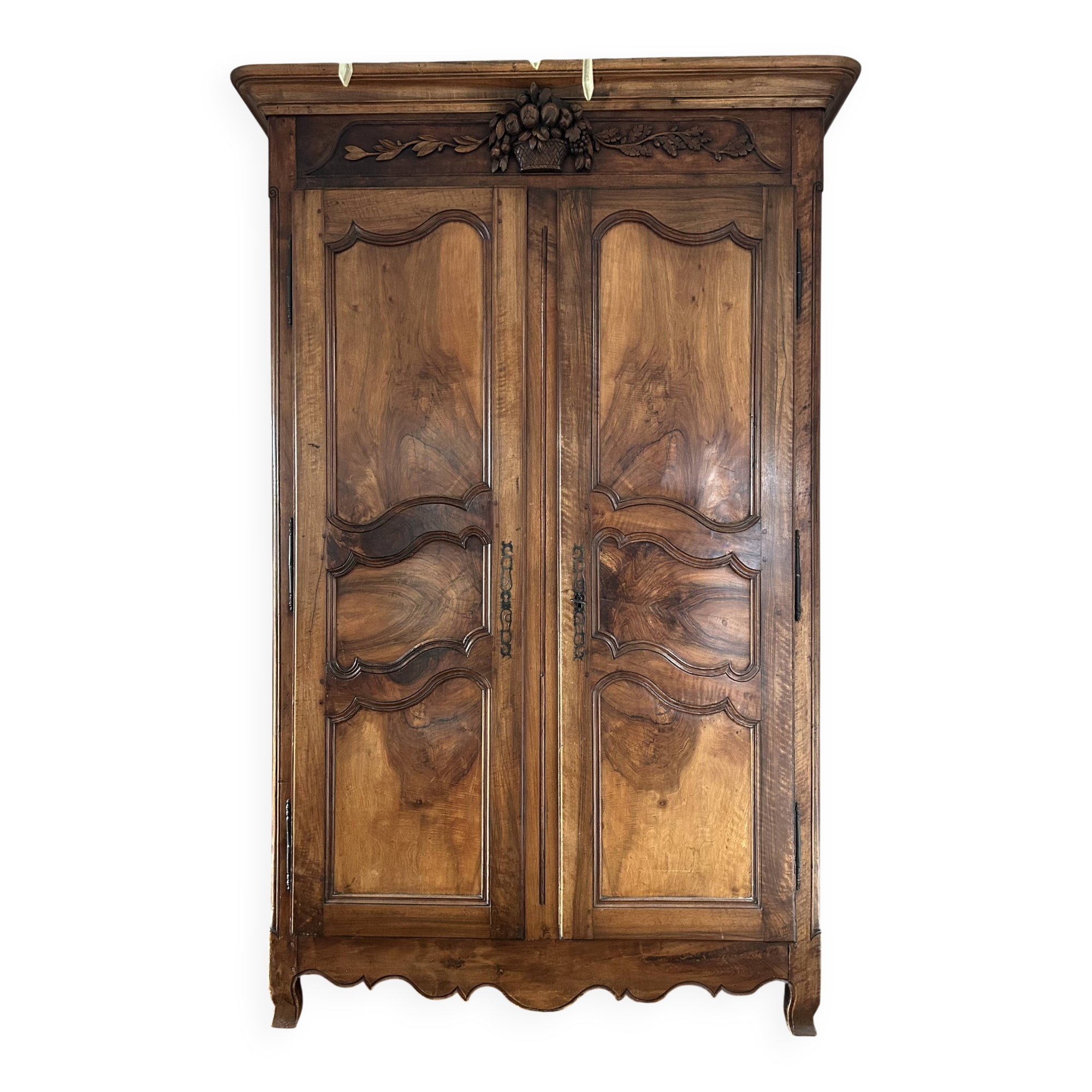 Antique walnut armoire with two doors.