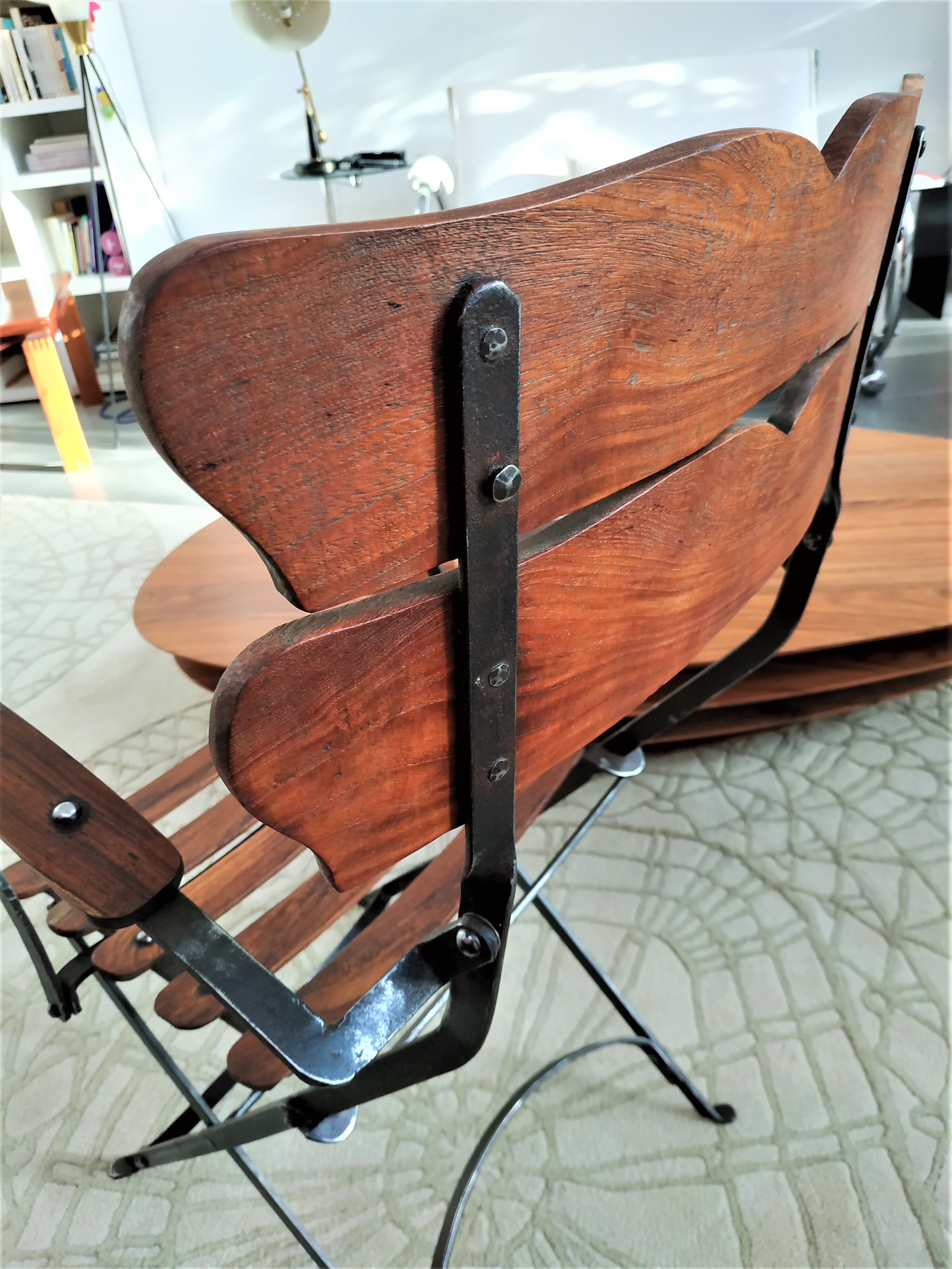Folding garden chair with teak slats on a wrought iron structure