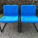 Electric blue fabric designer armchairs with black lacquered metal legs from the 80s.