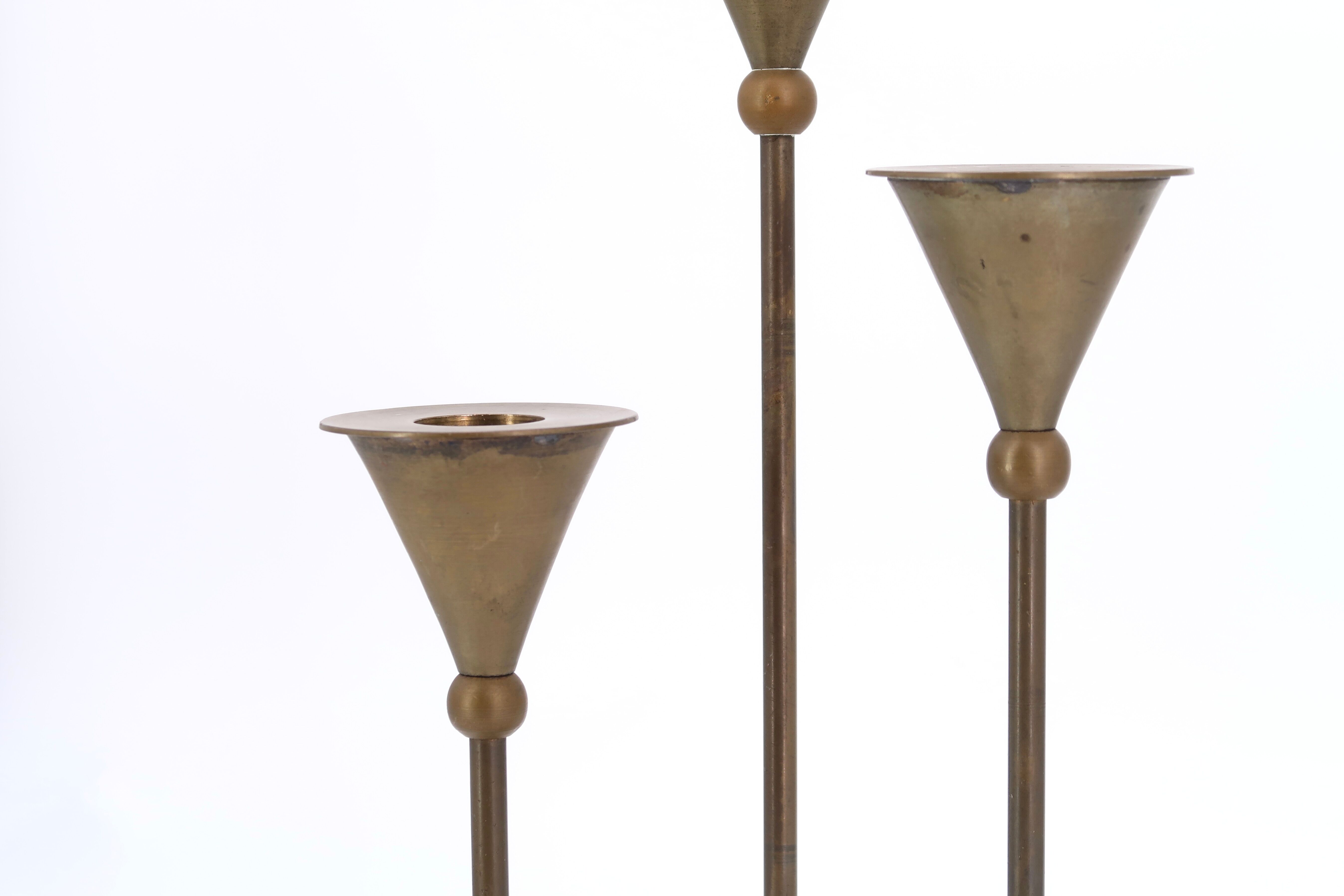 Trio of brass candlesticks by Christian de Beaumont