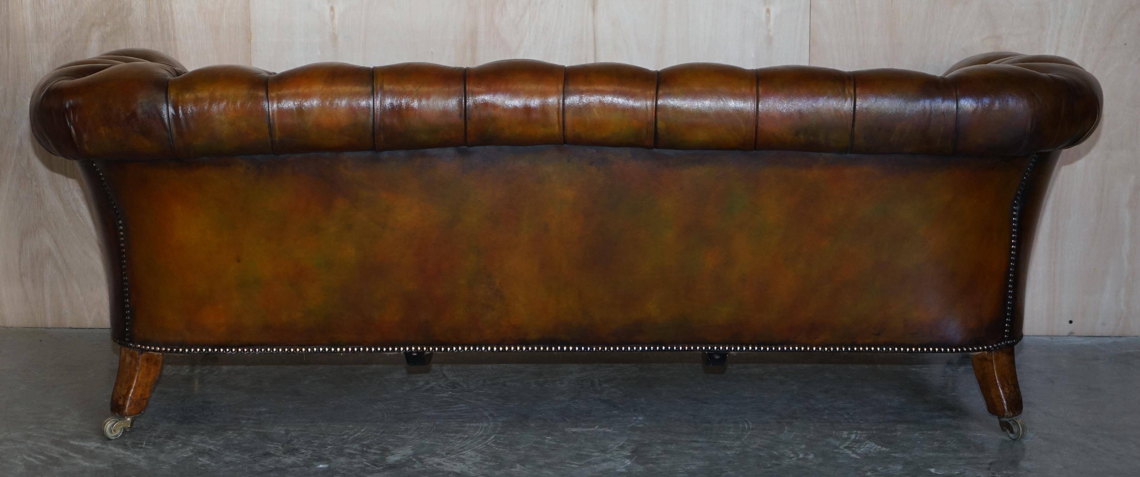 Pair of leather Chesterfield sofas by Howard & Sons