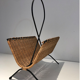 Rattan and black lacquered metal magazine rack