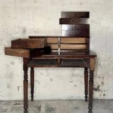 Wooden lady's desk says "happiness of the day"