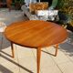 Round extendable teak dining table from the 60s