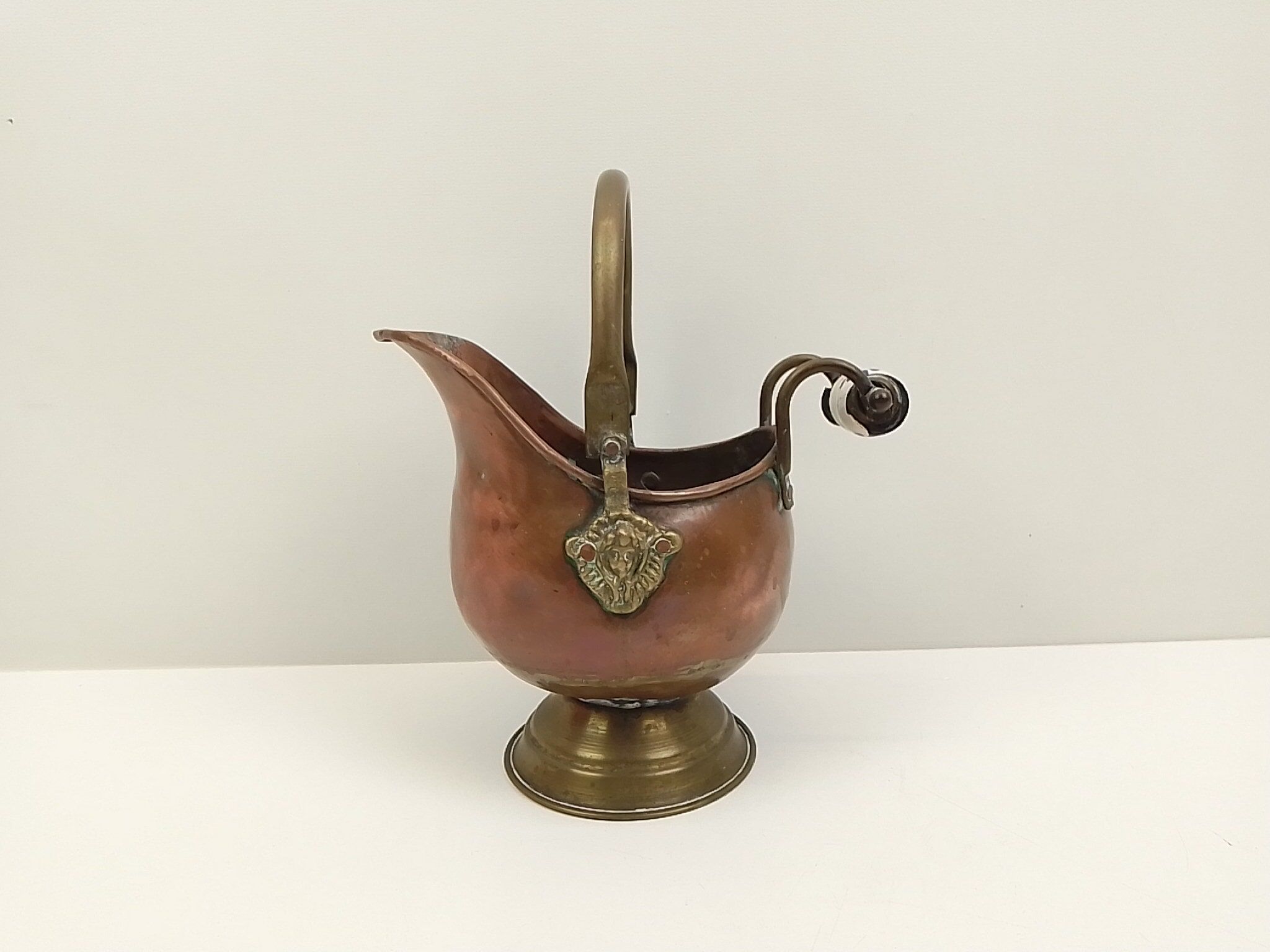 Copper pot cover and a pitcher-style brass handle