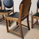 Set of four vintage wooden dining chairs with black leather upholstery