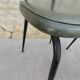Black metal chairs with khaki faux leather seats, circa 1960.